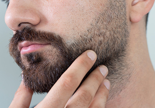 Total Hair Restoration man checking out beard