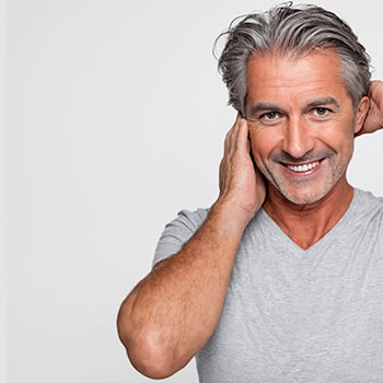 Total Hair Restoration man running hands through hair