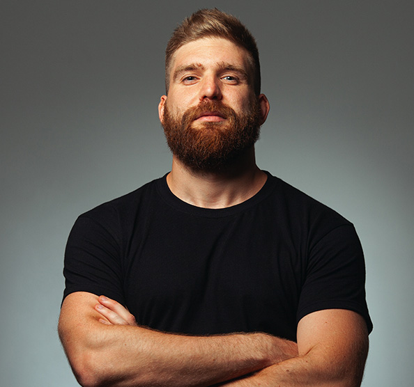 Total Hair Restoration man standing with arms folded